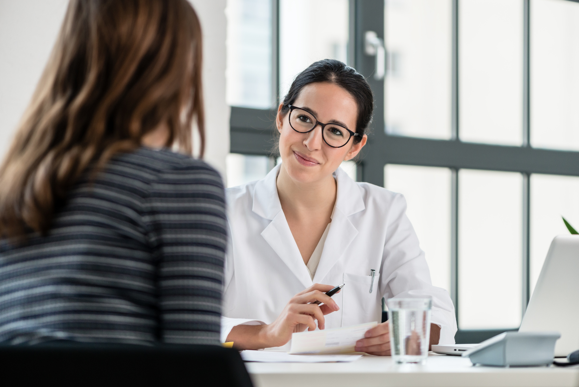 female_physician_listening_to_her_patient